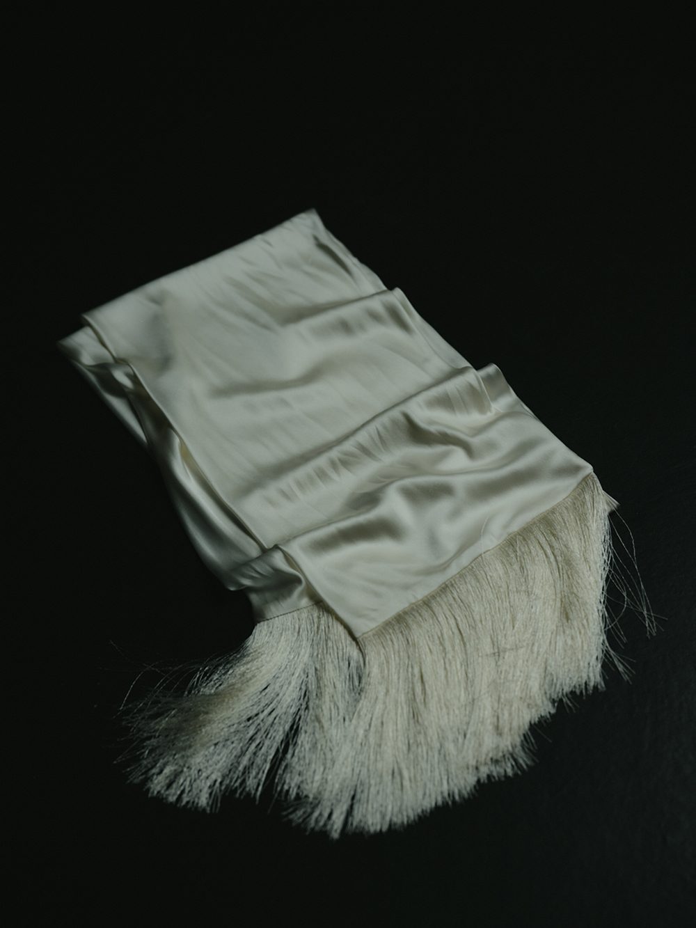 The After: a silk sash with fringe, left behind